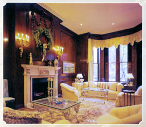 Formal Living Room with Fireplace and warm wood paneled walls by Connaughton Construction