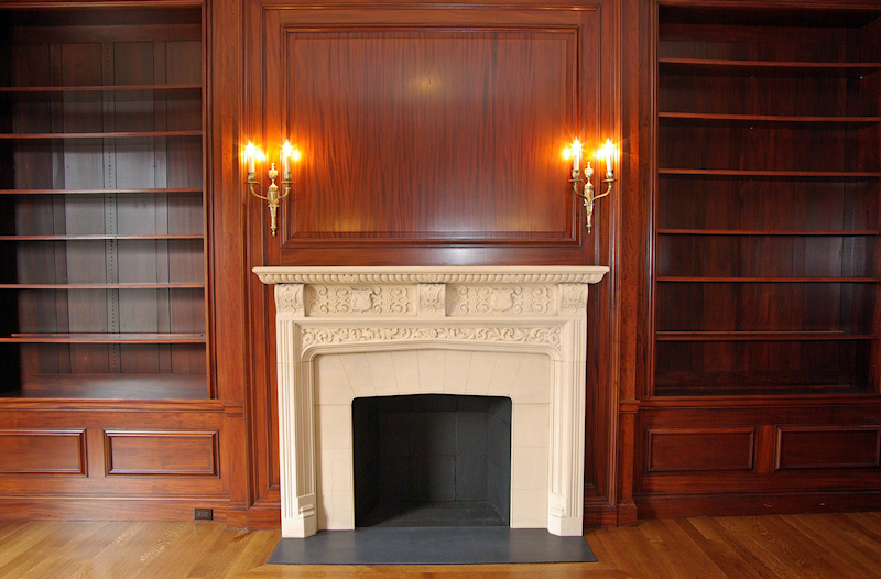 Book case flanked Limestone Fireplace